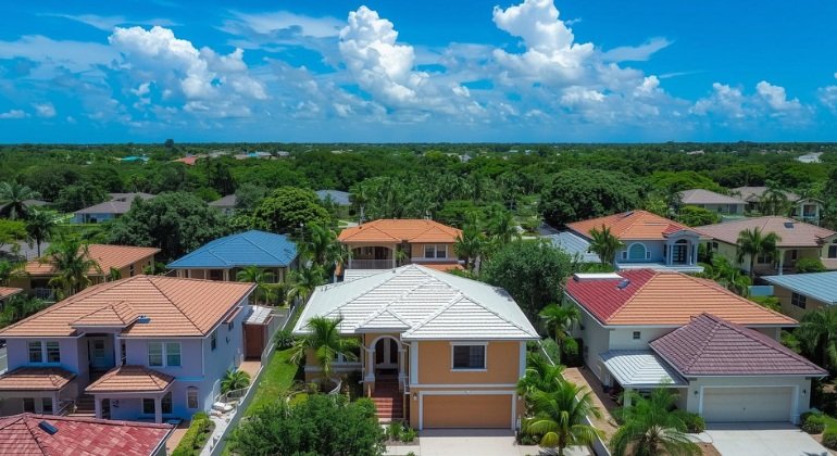 Aerial view of a South Florida neighborhood with hurricane-resistant roofs, showcasing community and resilient infrastructure