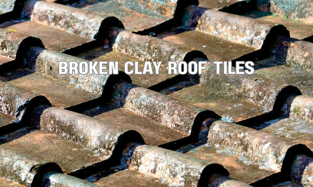 Broken clay roof tiles showing fragility and damage on a terracotta tiled roof