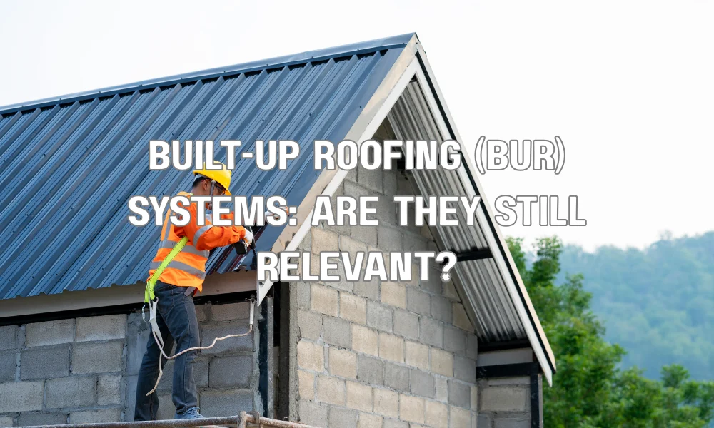 Built-up roofing (BUR) system showing multiple asphalt and felt layers with gravel surface on a flat commercial roof