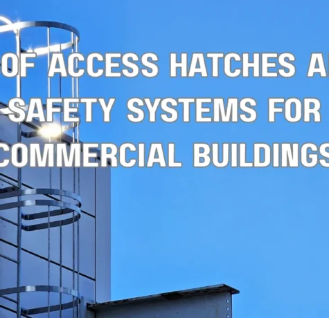 Commercial building roof access hatch with safety railing and ladder system installed for safe rooftop entry