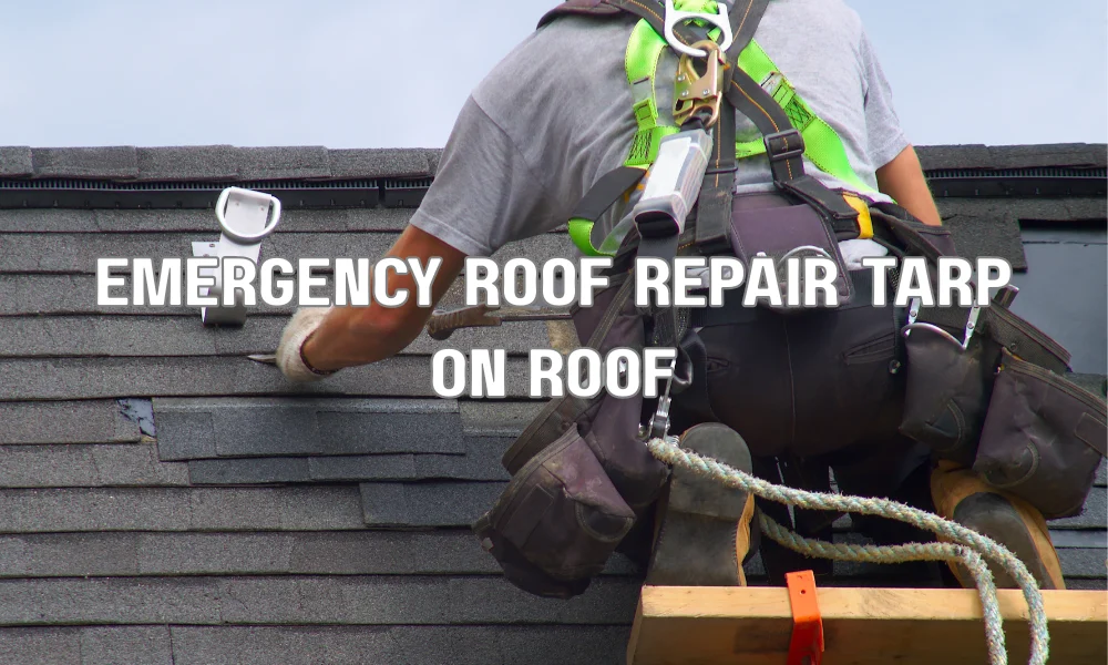 Roofing contractor installing emergency tarp on damaged roof to prevent water intrusion