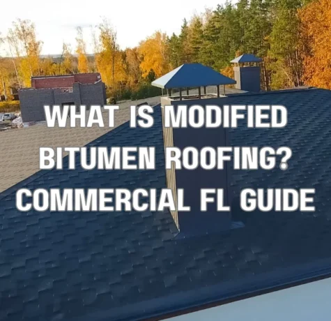 Workers installing modified bitumen roofing membrane on a commercial flat roof