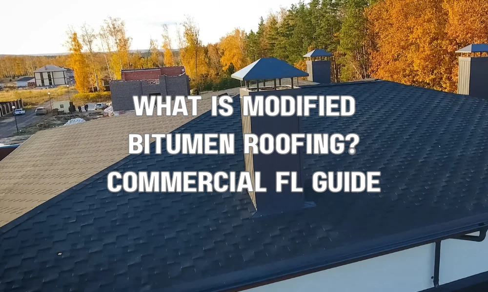 Workers installing modified bitumen roofing membrane on a commercial flat roof