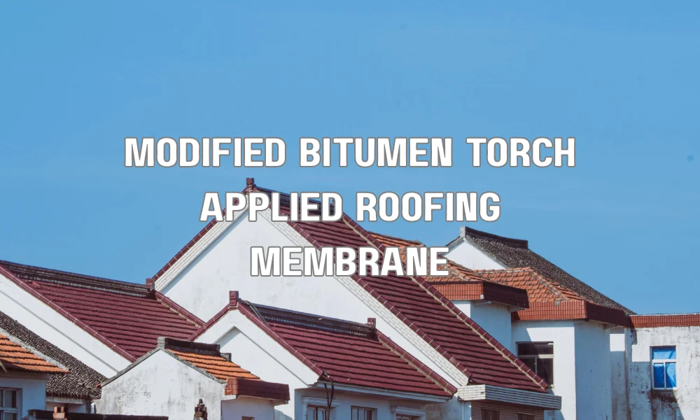 Contractor installing modified bitumen roofing membrane using torch-applied method on flat roof