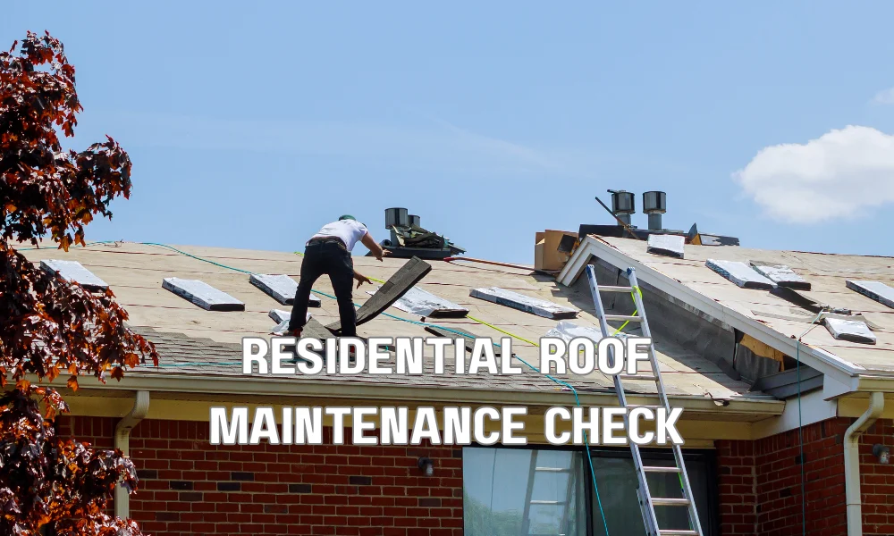 A detailed image of a technician on a residential roof, checking flashing around a vent stack and cleaning debris from nearby gutters, with solar panels visible in the background.