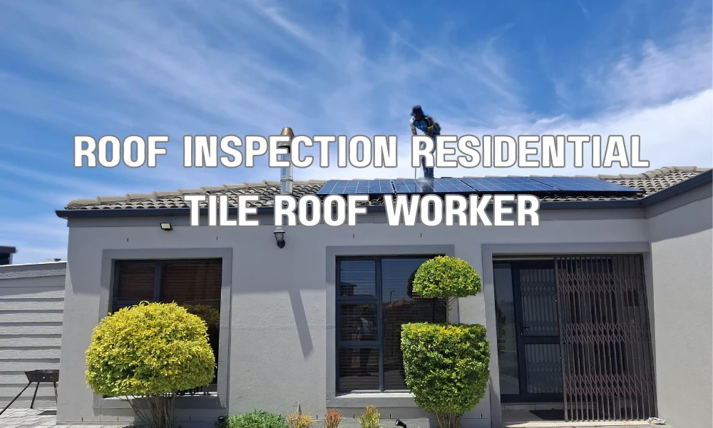 Professional roofer inspecting and maintaining a residential tile roof during routine estate roof maintenance