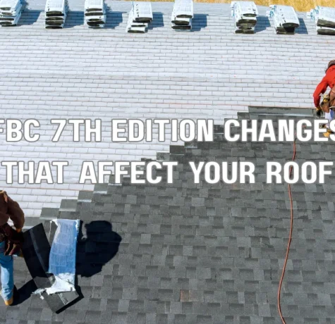 Roof inspector examining asphalt shingles to ensure compliance with FBC 7th Edition roofing code changes