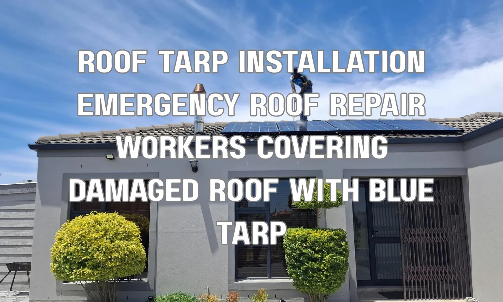 Workers installing a blue tarp over a damaged residential roof to prevent water damage