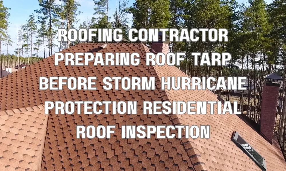Roofing contractor securing protective tarp and preparing residential roof before hurricane season