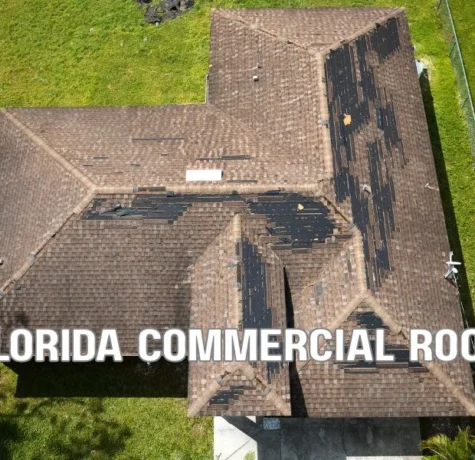 Professional commercial roofing contractor inspecting a flat roof in Florida with safety equipment, roofing materials, and modern commercial building under a clear blue sky.
