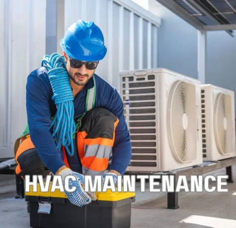 Technician inspecting rooftop HVAC units and roof penetrations on a commercial flat roof, highlighting foot traffic, flashing details, and areas vulnerable to leaks and membrane damage.