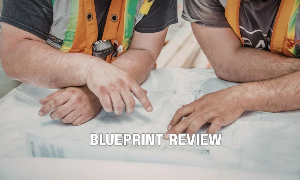 Commercial roofing contractor reviewing permit documents and construction plans with a municipal building official during the approval process for a Florida commercial re-roofing project.