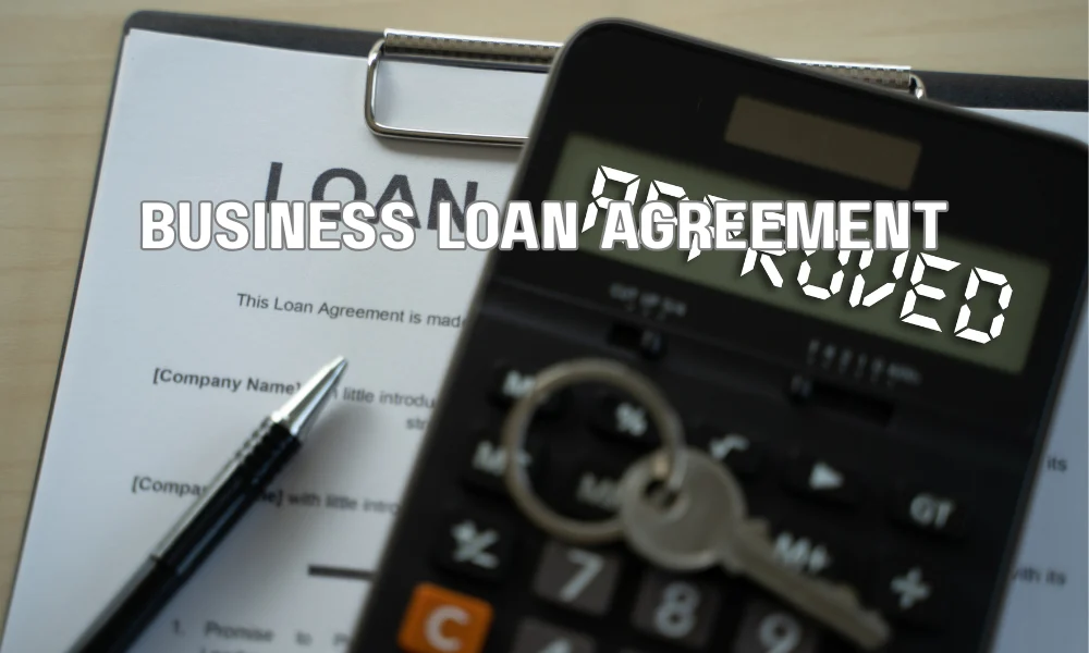 Business owner reviewing commercial roofing financing documents showing loan terms, interest rates, and repayment options.
