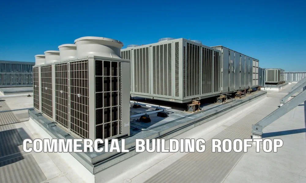 Technician performing a detailed commercial roof inspection, examining membrane, flashing, drains, HVAC units, and roof penetrations for signs of damage. Inspecting seams, ponding water, debris, and drainage components to ensure long-term roof performance and prevent leaks.
