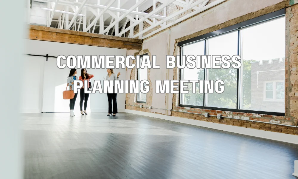 Business owners reviewing a commercial roof financing plan with a financial advisor to secure funding for a roof replacement project.