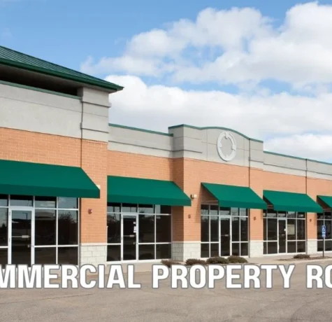Commercial flat roof with roofing materials, warranty documents, and contractor inspection illustrating NDL, material-only, and workmanship commercial roof warranties.