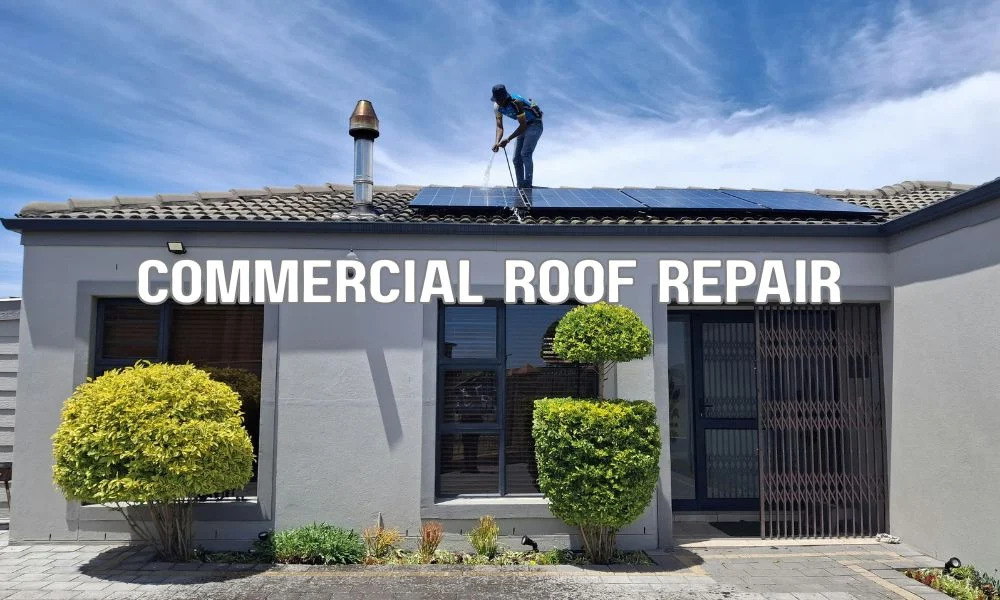 Commercial roofing contractor repairing a small damaged section of a flat roof with localized membrane patch and flashing repair on a well-maintained commercial building.