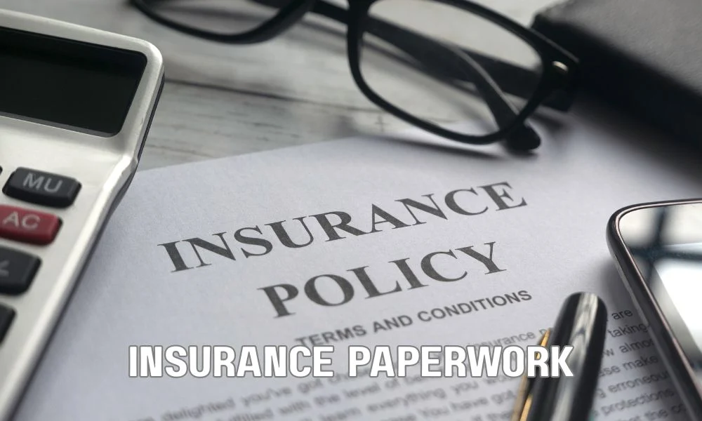 Property owner reviewing commercial roof warranty documents, inspection reports, maintenance records, and roof damage photos before filing a warranty claim. Professional office setting with organized paperwork, laptop, and roofing documentation emphasizing warranty compliance and claims process.