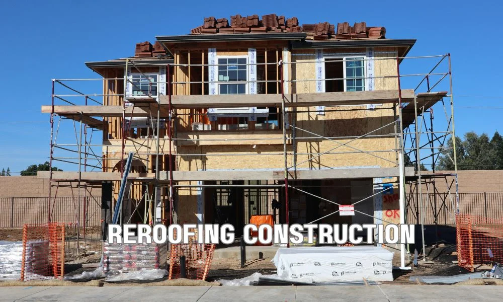 Professional roofing contractors removing old roofing materials and installing new roof decking and underlayment during a residential re-roofing project to meet modern building and energy code requirements.