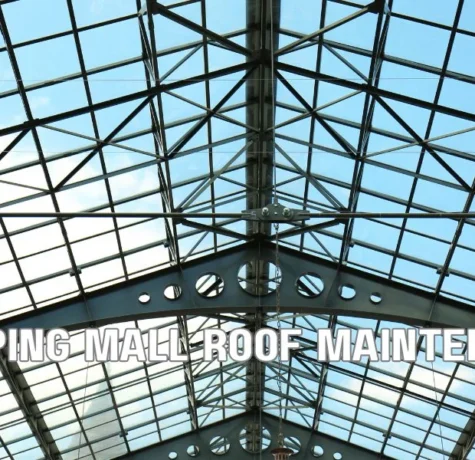 Commercial retail shopping center with a flat roof undergoing maintenance, showcasing multi-tenant storefronts, rooftop HVAC systems, and professional roofing inspection.