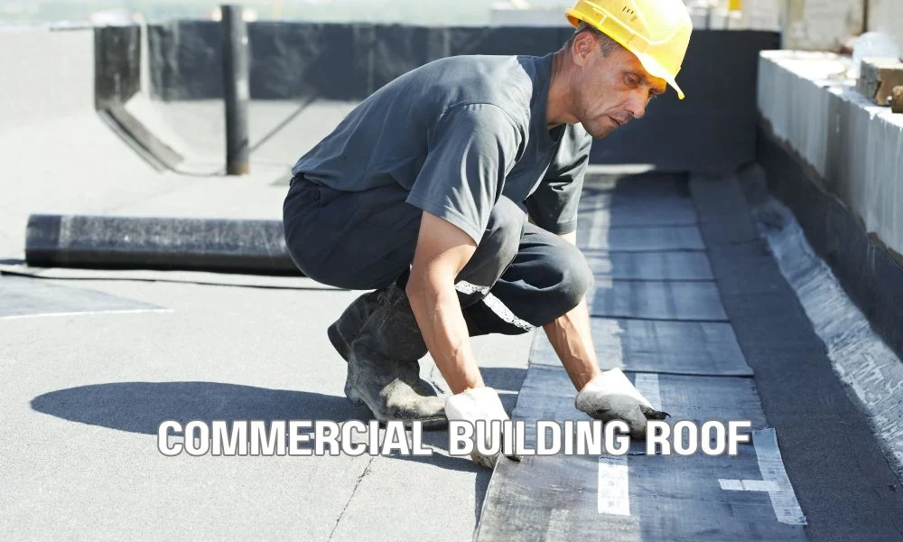 Commercial roofing contractor inspecting a storm-damaged commercial roof while preparing emergency repairs with safety equipment to protect the building from further water damage.